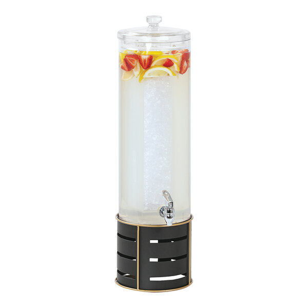 A Cal-Mil round beverage dispenser with ice chamber and metal base filled with water, fruit, and ice.