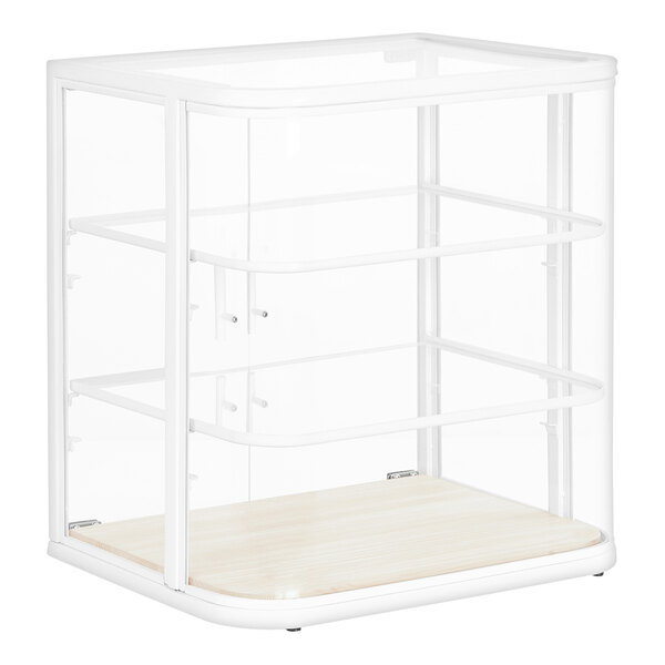 A white glass bakery display case with a wood shelf.