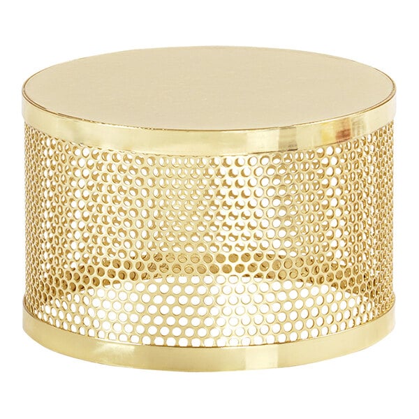A gold metal round display riser with circular holes in it.