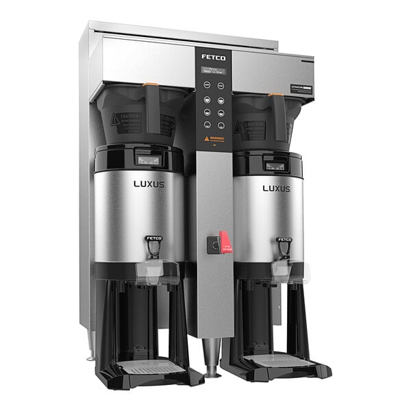 A Fetco CBS-1252 Plus Series twin automatic coffee machine with plastic brew baskets.