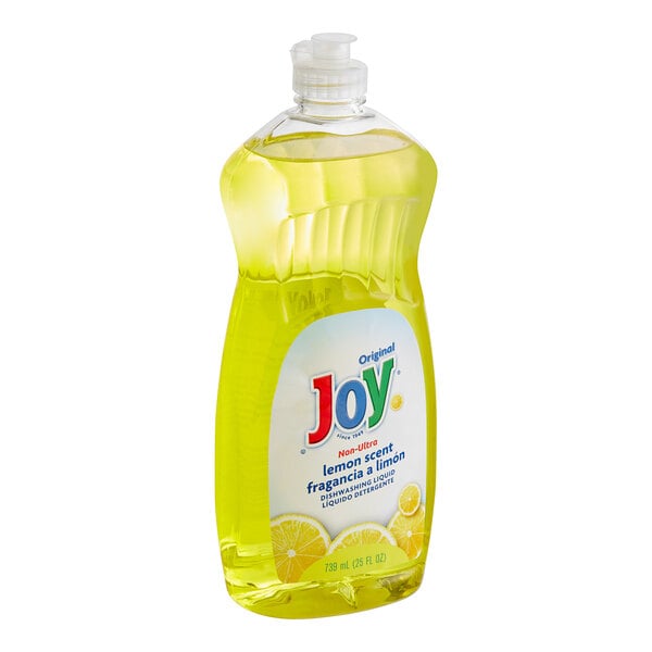 A bottle of Joy dishwashing liquid with a yellow label and cap on a counter.