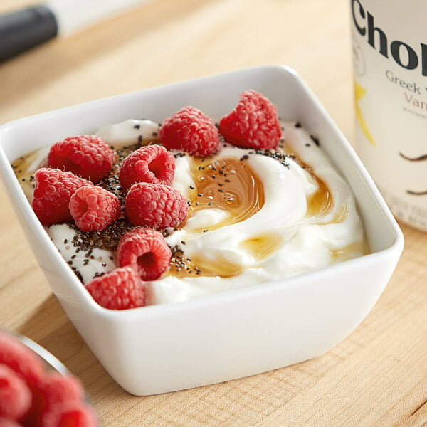 A bowl of Chobani Non-Fat Vanilla Greek Yogurt with raspberries.