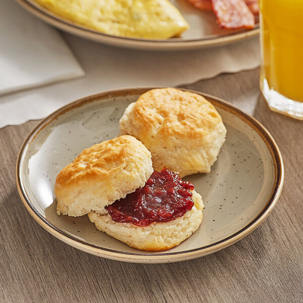 A plate with two Bakery Chef buttermilk biscuits and jam.