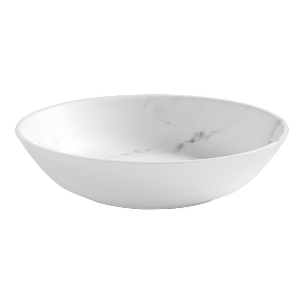 A white bowl with marble on it.