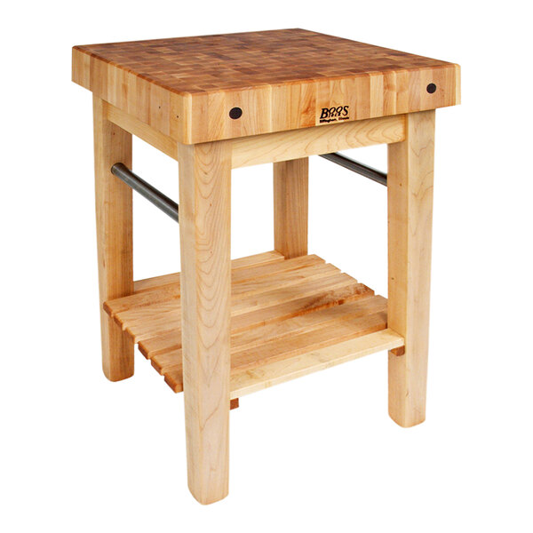 A John Boos maple wood table with a shelf underneath and towel bars.