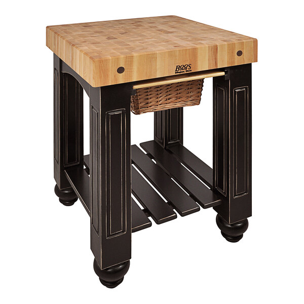A wood and black butcher block table with a basket.