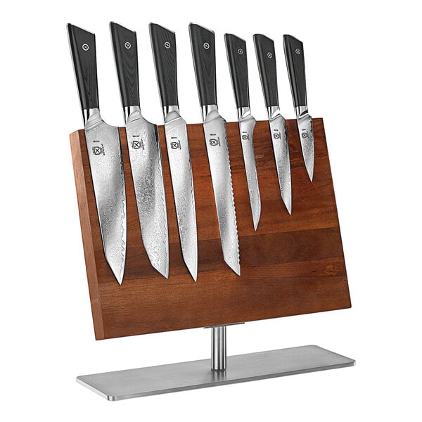 A Mercer Culinary Damascus knife set on a wooden stand.