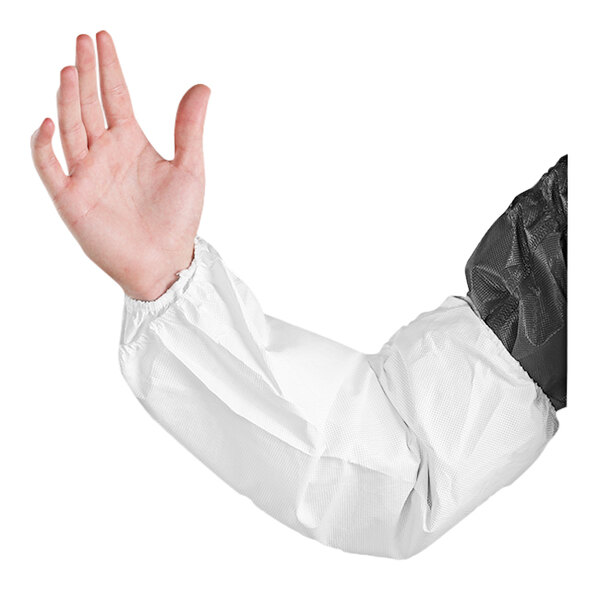 A person wearing a white Ansell polyethylene sleeve with a black and white coat.