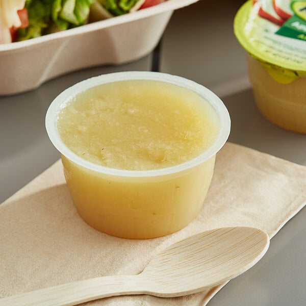 A plastic container of Mott's Original Applesauce with a yellow lid.