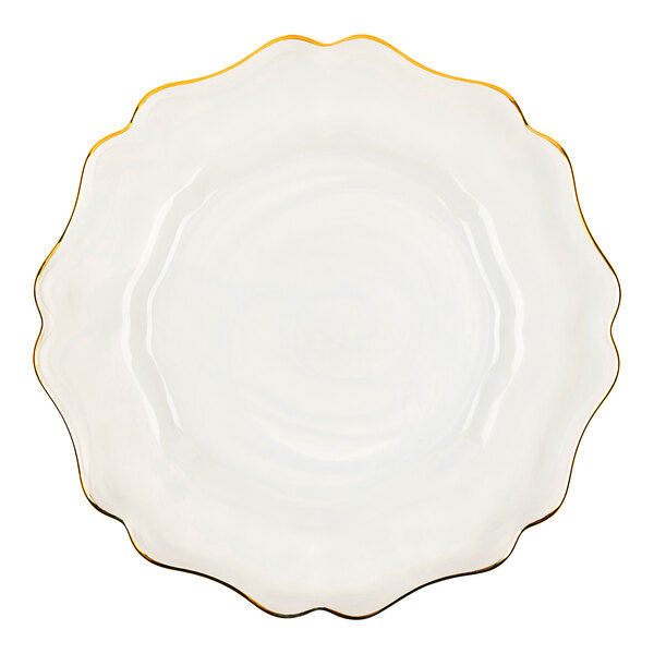 A white American Atelier charger plate with a scalloped edge and gold rim.