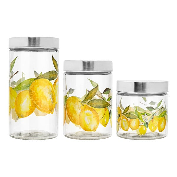 A group of American Atelier glass canisters with lemon paintings on them.