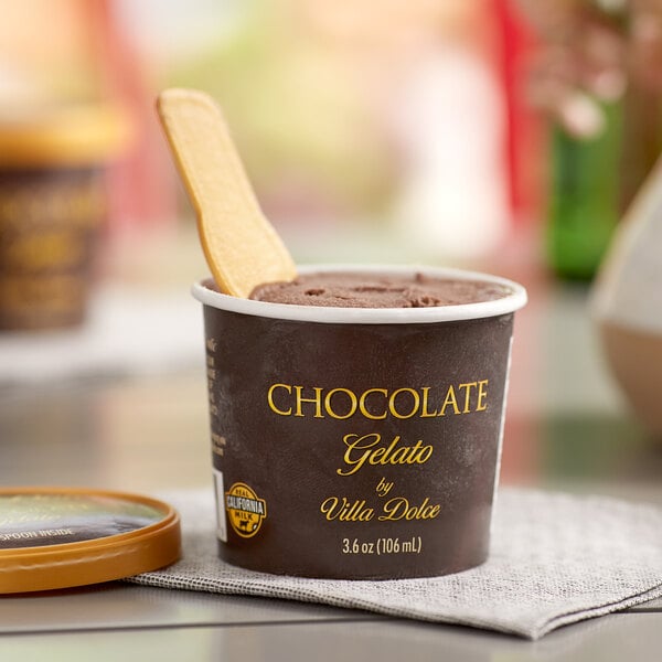 A close up of a Villa Dolce Dark Chocolate Gelato cup with a spoon in it.