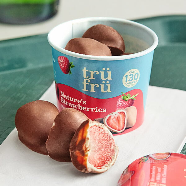 A container of TruFru frozen white and milk chocolate covered strawberries.