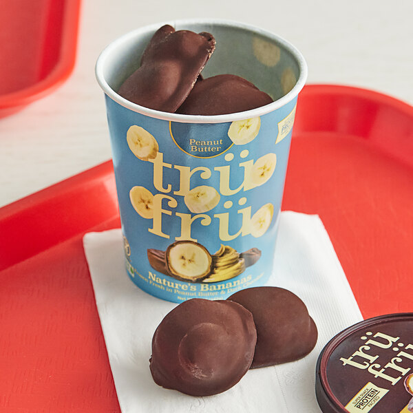 A white container of TruFru frozen chocolate covered bananas.