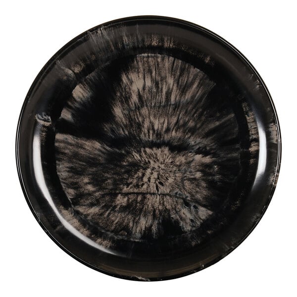 A black and ivory melamine plate with a circular black and ivory design.