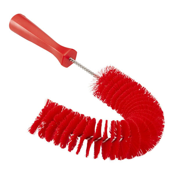 A red plastic Vikan brush with a long handle.