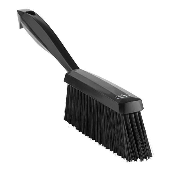 A black Vikan hand brush with a handle.