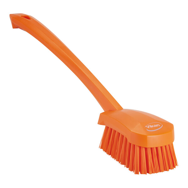 A Vikan orange washing brush with a handle.