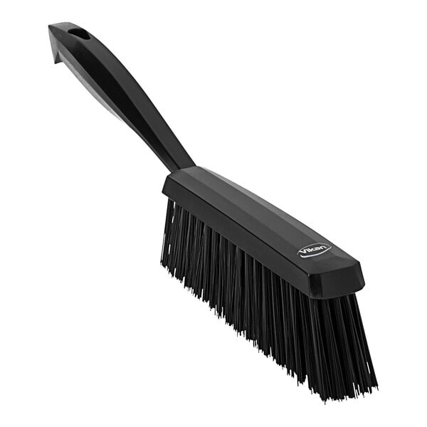 A black hand brush with a handle.