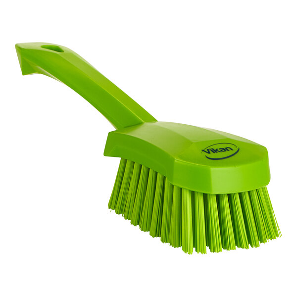 A lime green Vikan pot and pan brush with a long handle.