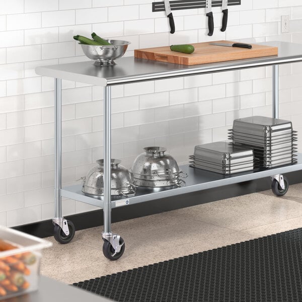 A Steelton stainless steel work table with casters and an undershelf holding food items.