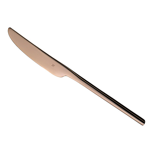A WMF stainless steel table knife with a long copper standing blade and handle.