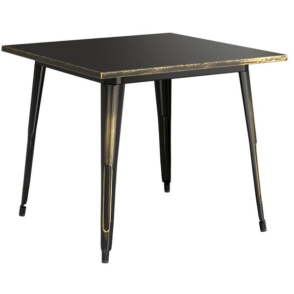 A Lancaster Table & Seating distressed gold outdoor dining table with metal legs.