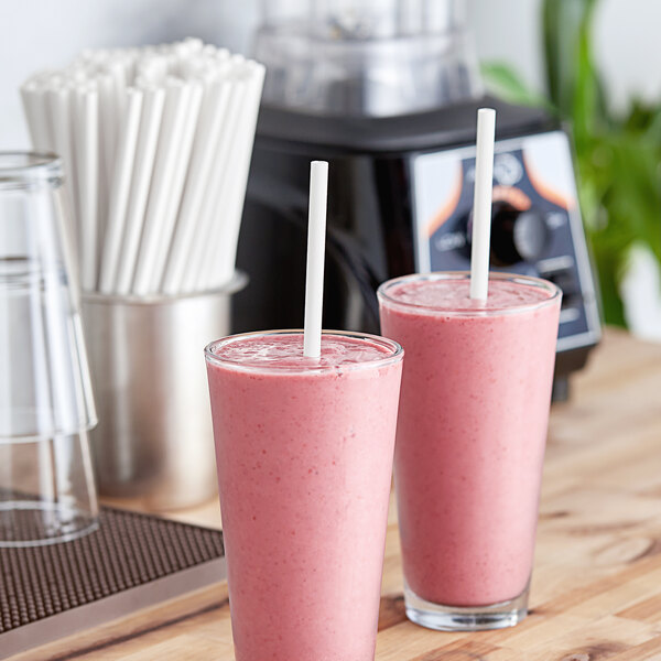 Two glasses of pink smoothies with Aardvark white straws.
