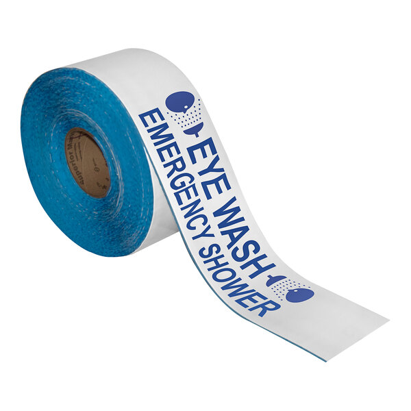 A roll of white and blue Superior Mark safety tape with the words "Eye Wash Emergency Shower" on it.
