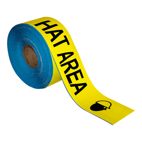 A roll of yellow Superior Mark safety tape with the words "Hard Hat Area" in black.