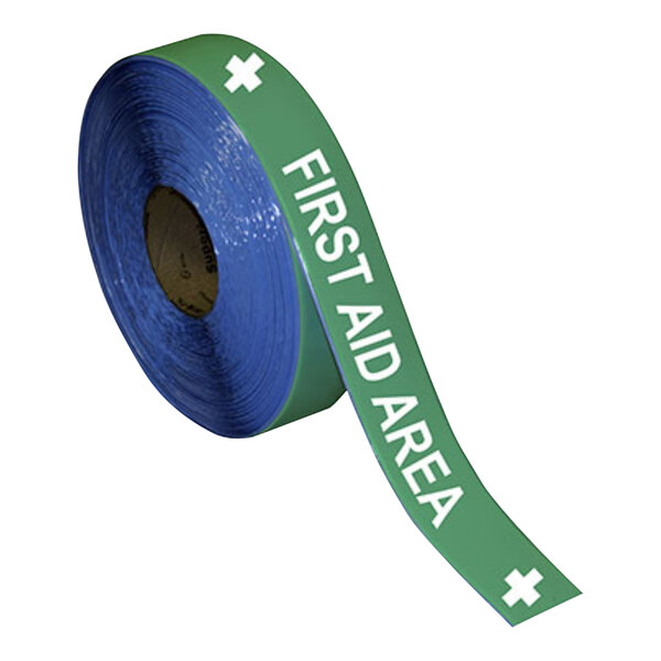 A roll of green and white Superior Mark safety tape with the words "First Aid Area"