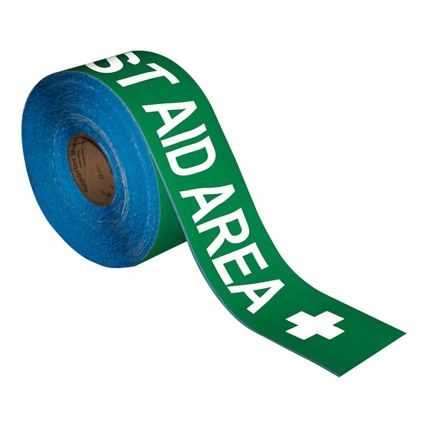 A roll of green tape with white text that reads "First Aid Area"