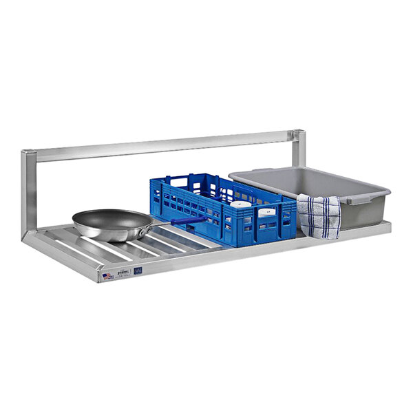 A New Age aluminum T-bar wall shelf with inverted brackets holding pans.