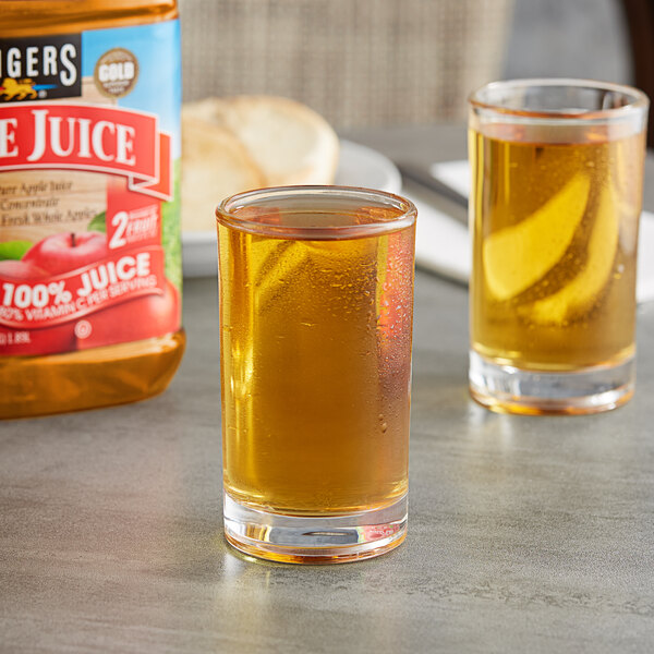 A close up of a glass of Langers apple juice.