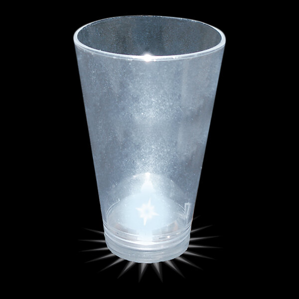 A clear plastic shot cup with a white LED light shining on it.