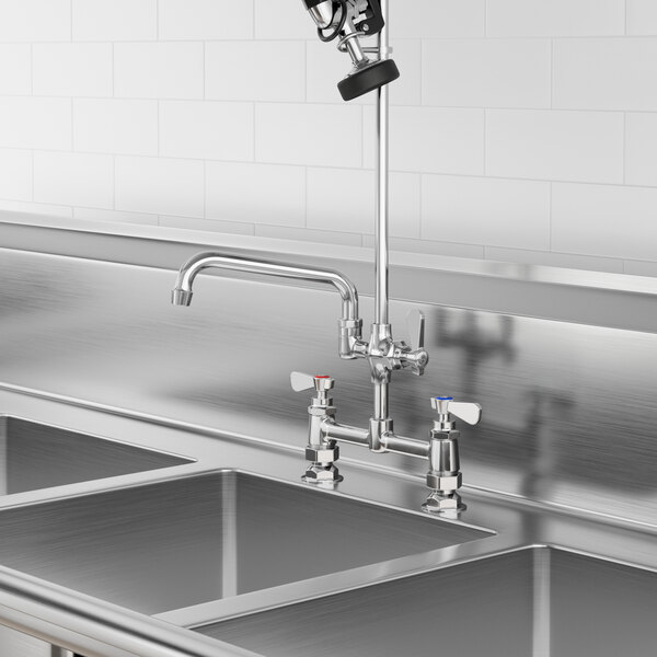 A stainless steel sink with a Regency add-on faucet and swing spout.
