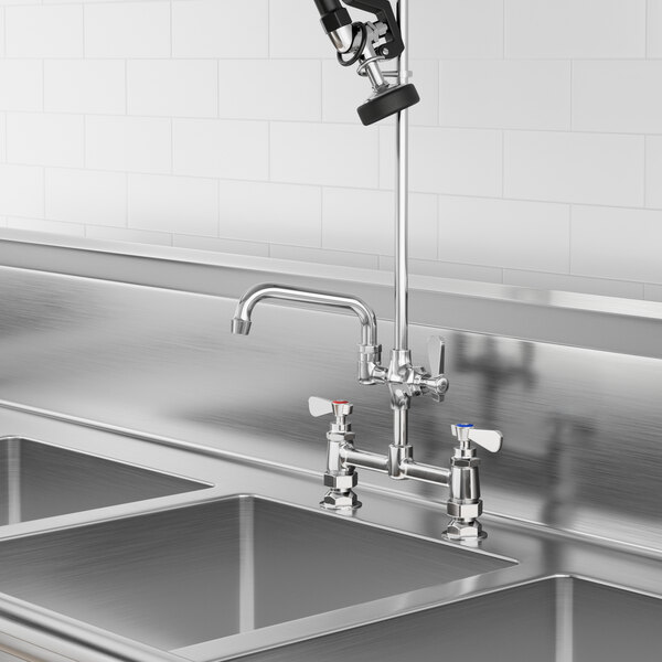 A Regency add-on faucet with a 6" swing spout on a sink in a kitchen.