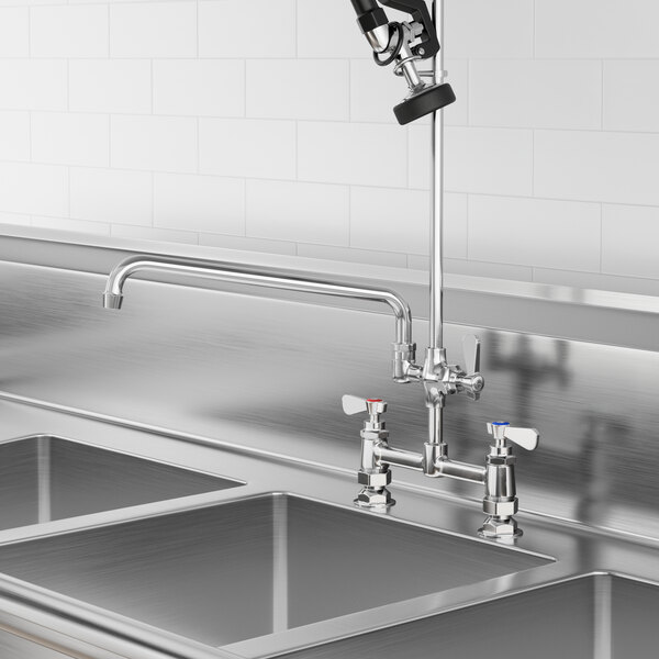A Regency pre-rinse add-on faucet with 14" swing spout installed on a sink.