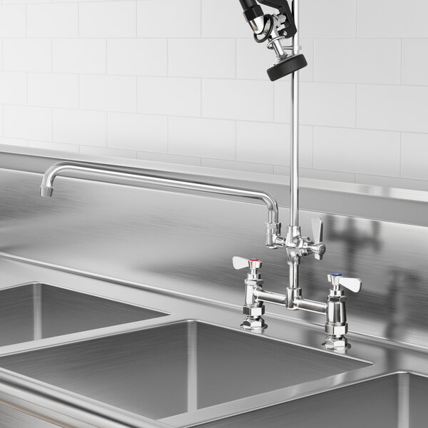 A Regency pre-rinse add-on faucet with a 16" swing spout above a sink in a professional kitchen.