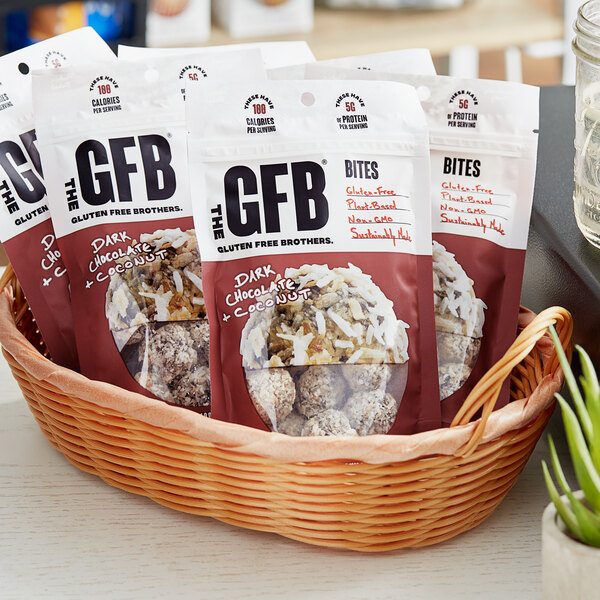 A basket filled with The GFB Dark Chocolate Coconut Bites.