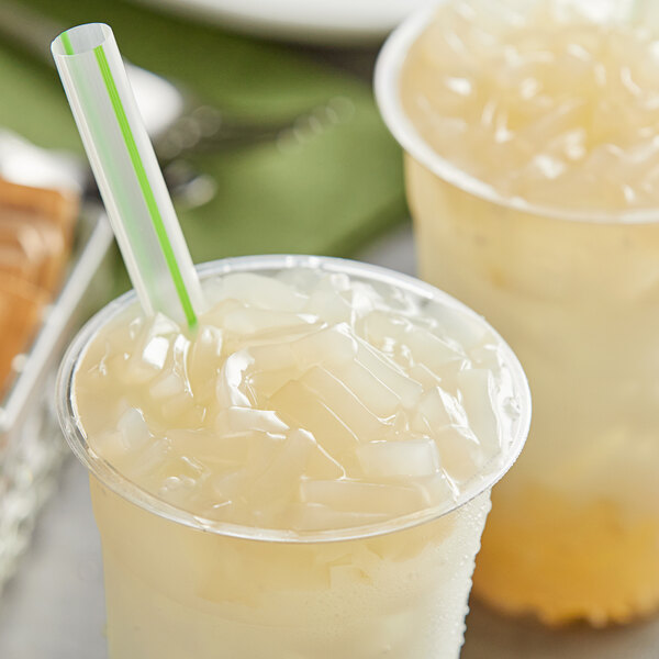 A plastic cup of ice with a green straw and Fanale Coconut Jelly Topping.