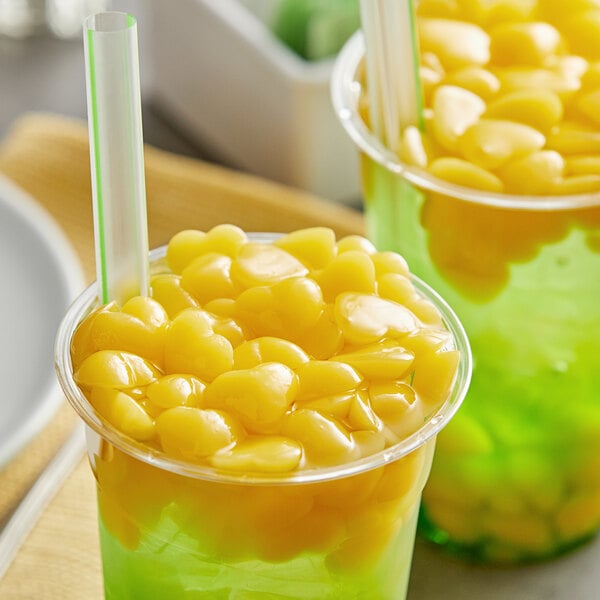 Two cups of green drinks with Fanale Mango Love yellow jelly topping.