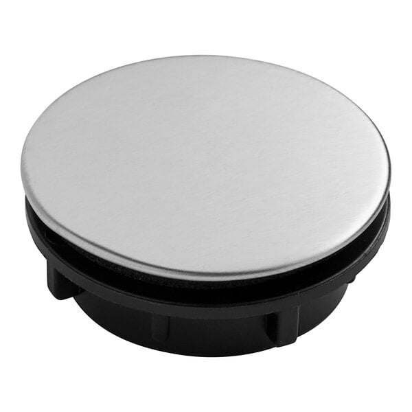A round metal faucet hole cover with black plastic.