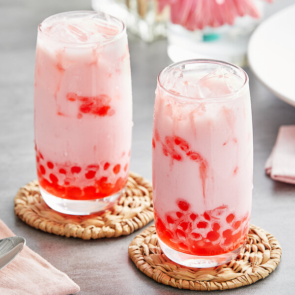 Two glasses of pink liquid with red bubbles, made with Fanale Guava Concentrated Syrup, with pink and white straws.
