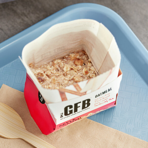 A tray with a bowl of The GFB apple cinnamon oatmeal on a counter.