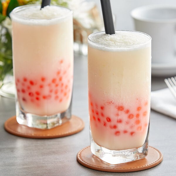 Two glasses of milkshakes with straws filled with Fanale Yogurt Concentrated Syrup
