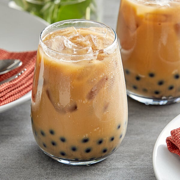 A glass of Fanale coffee bubble tea with ice and black pearls.