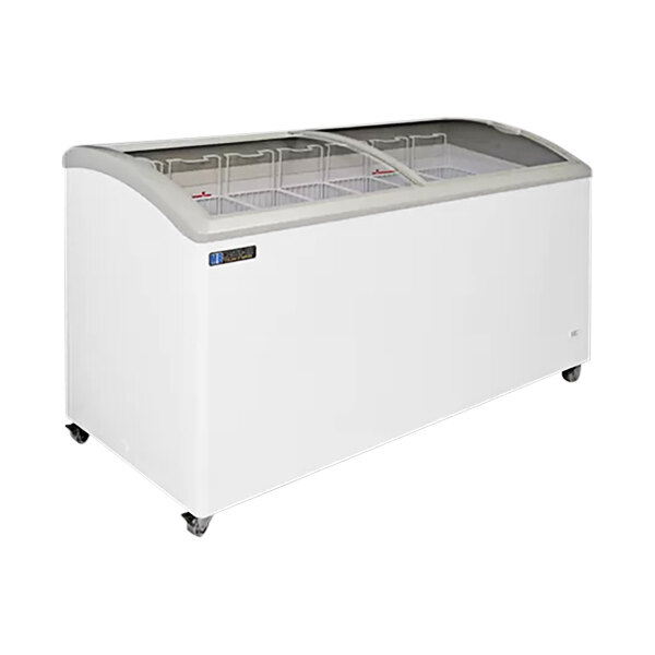 A white Master-Bilt curved top display freezer with glass doors on wheels.