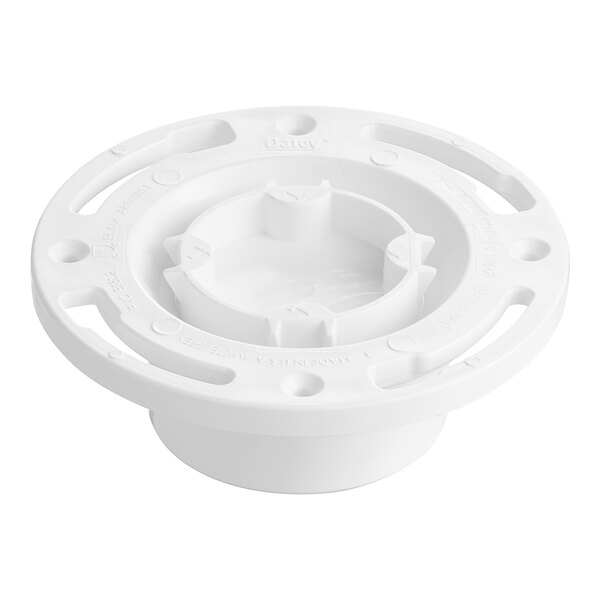 A white plastic Oatey water closet flange with a round top and holes in the center.
