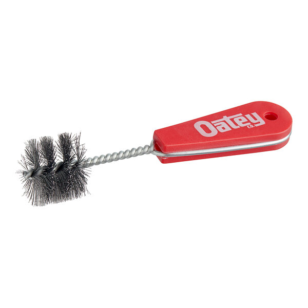 A small red Oatey 1 1/4" Fitting Brush with a metal handle.